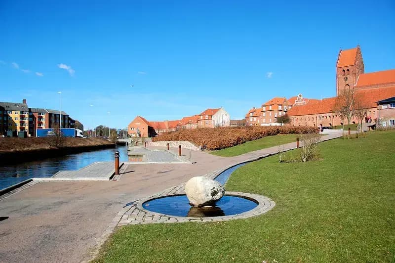 waterfront park with historic buildings and small rock pool