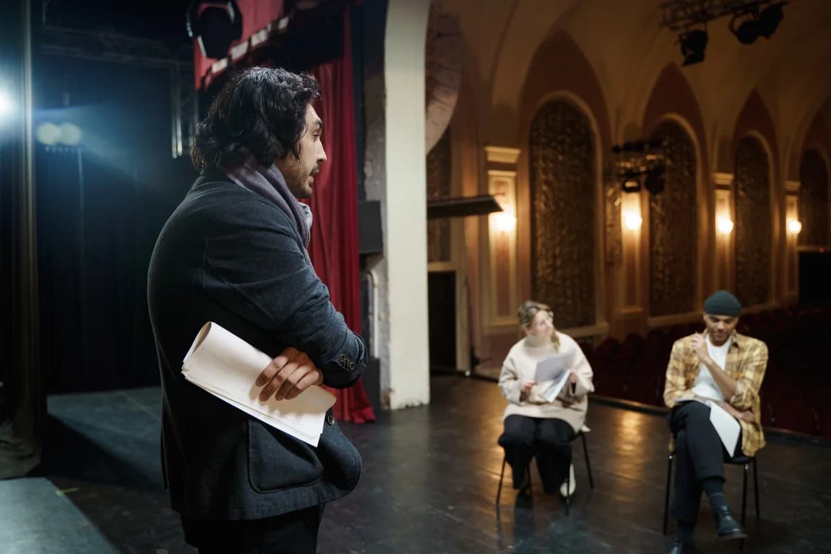 Director overseeing actors during a rehearsal in a vintage theater auditorium