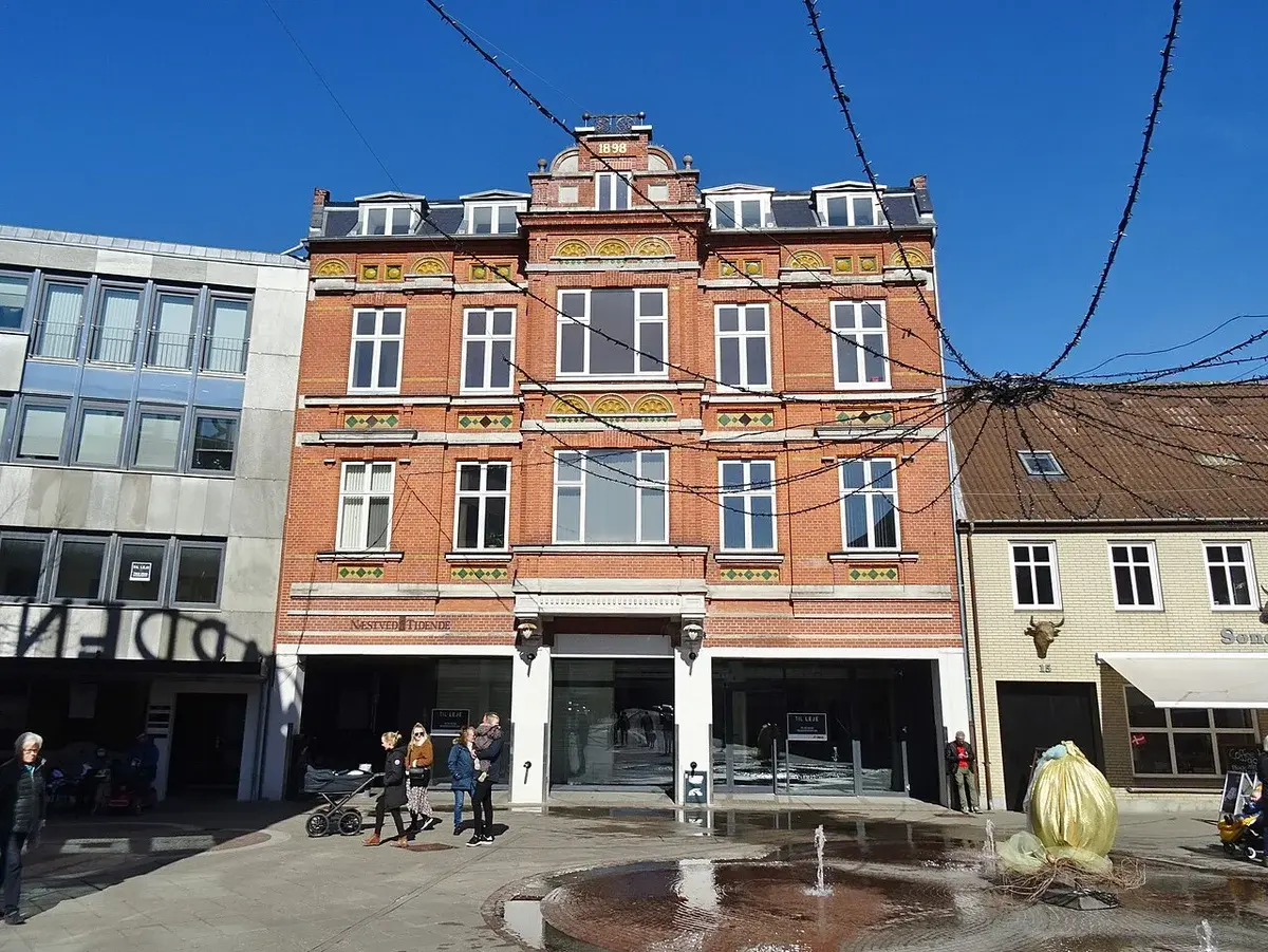 Former Næstved Tidende building with an Easter decoration in front.
