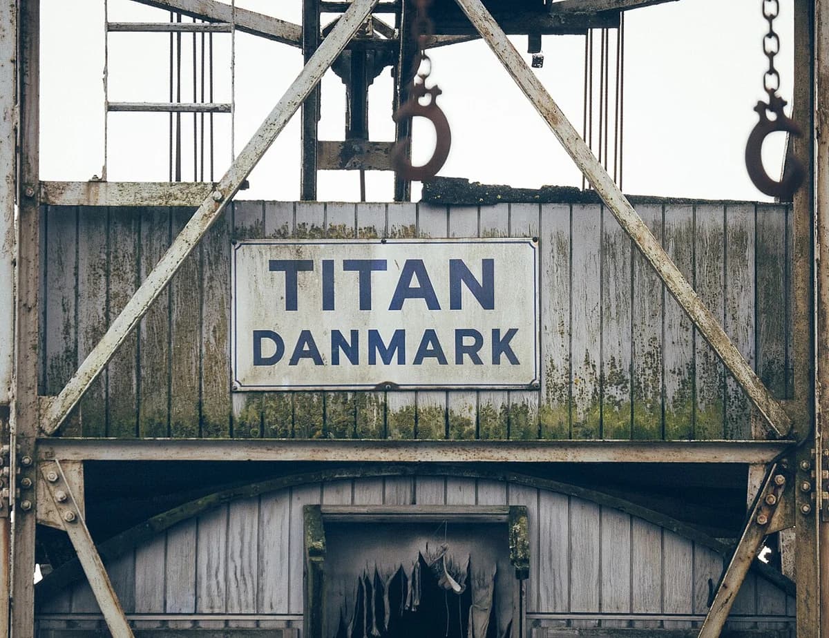 Weathered industrial building with a Titan Danmark sign.