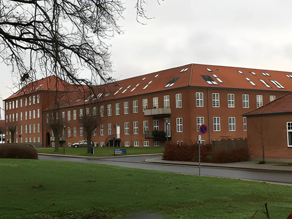 red brick apartment building in a residential area
