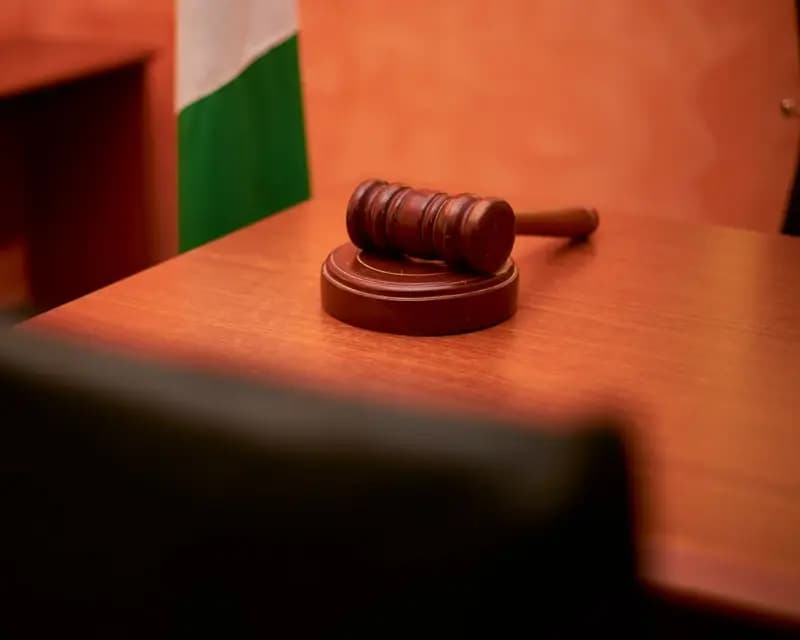 Judge's gavel on a wooden courtroom desk