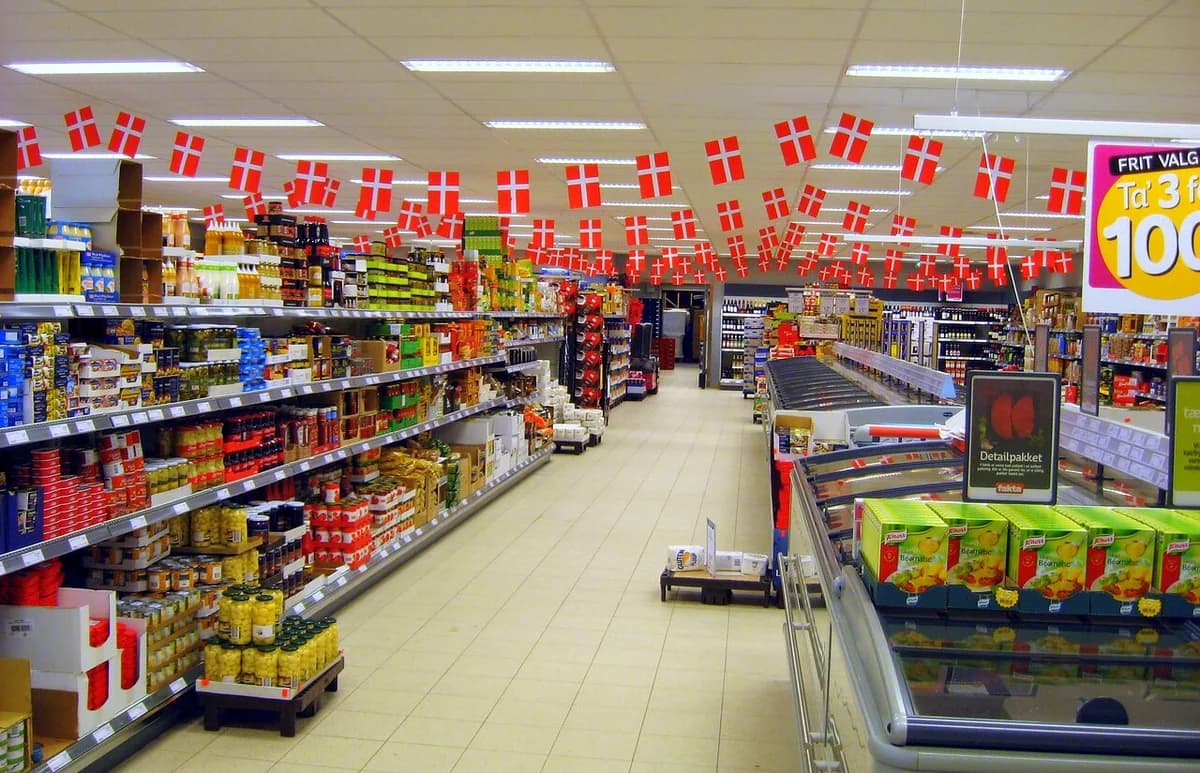 A supermarket aisle decorated with Danish flags.
