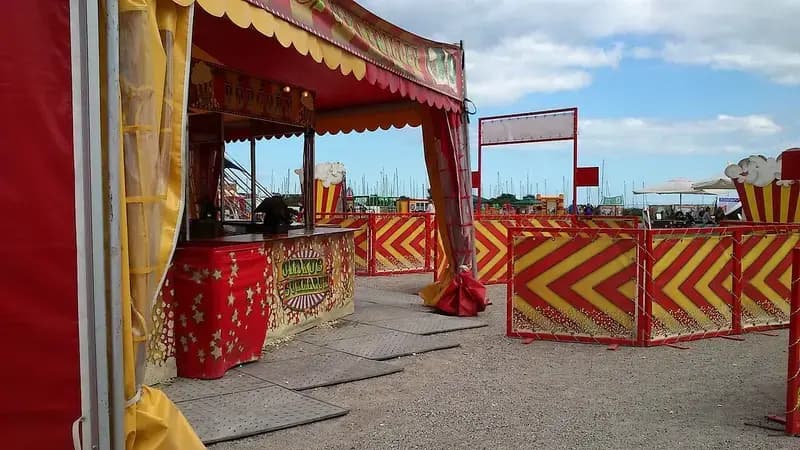 Circus food stand with red and yellow decorations at outdoor fairground