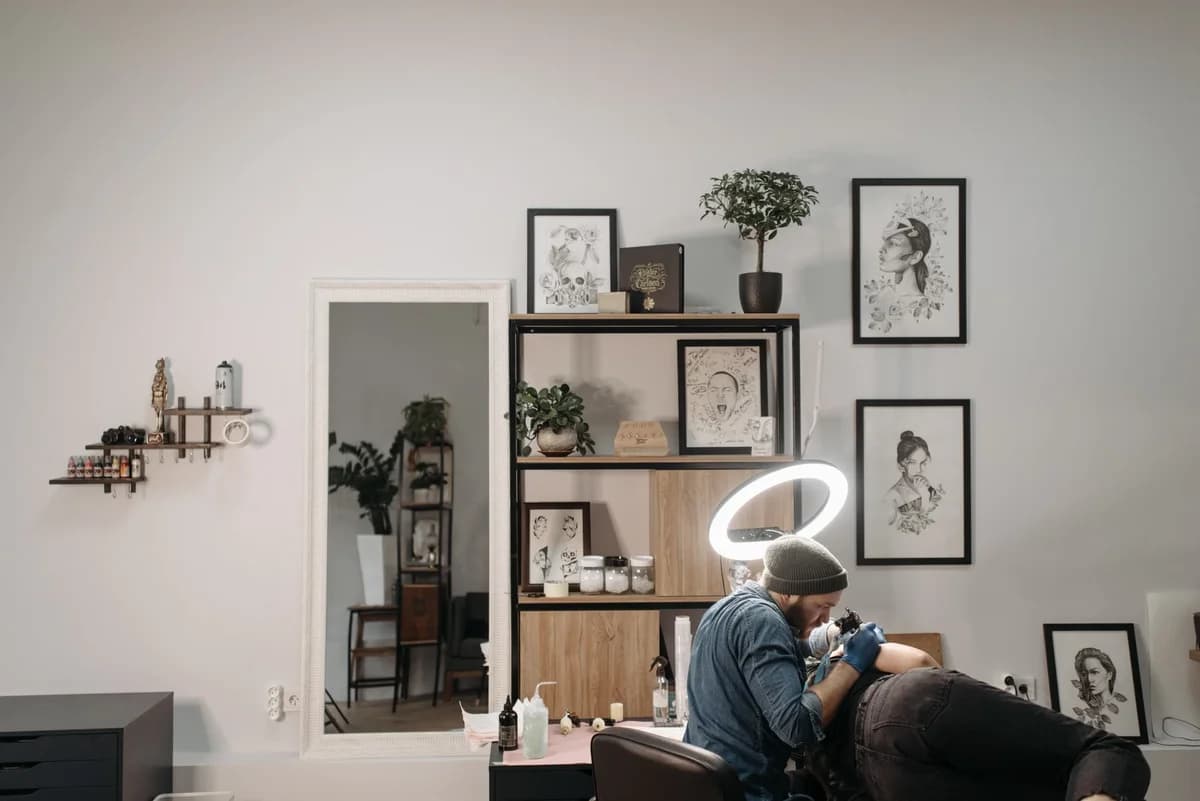 Tattoo artist working on a client in a modern tattoo studio