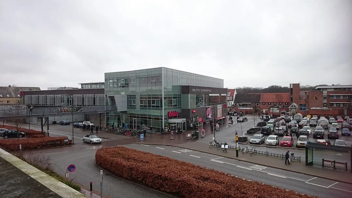 Modern commercial and public building complex with parking and bicycles in Næstved.