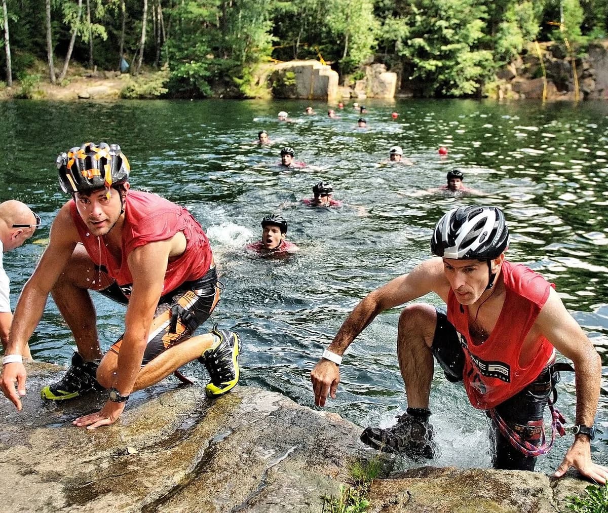 Athletes climbing out of a lake during adventure race